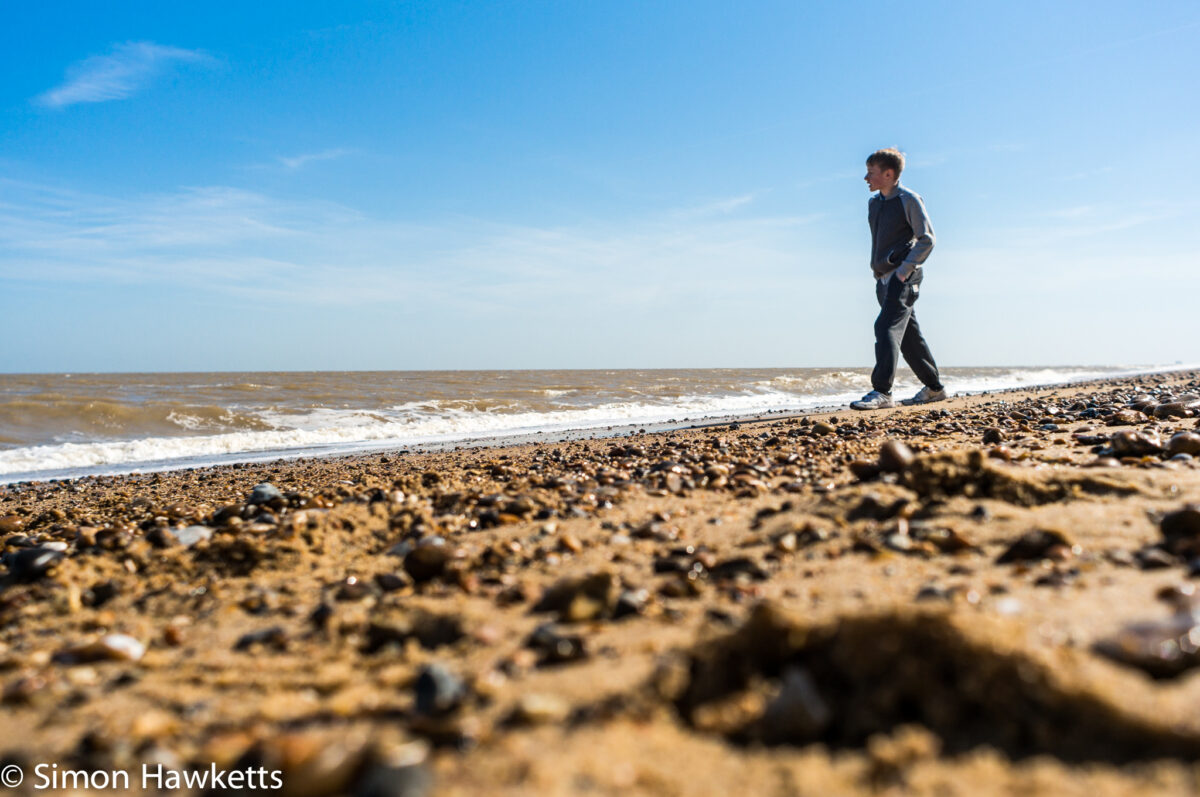 Dunwich Heath Suffolk pictures - A low perspective picture of a boy walking on the beach