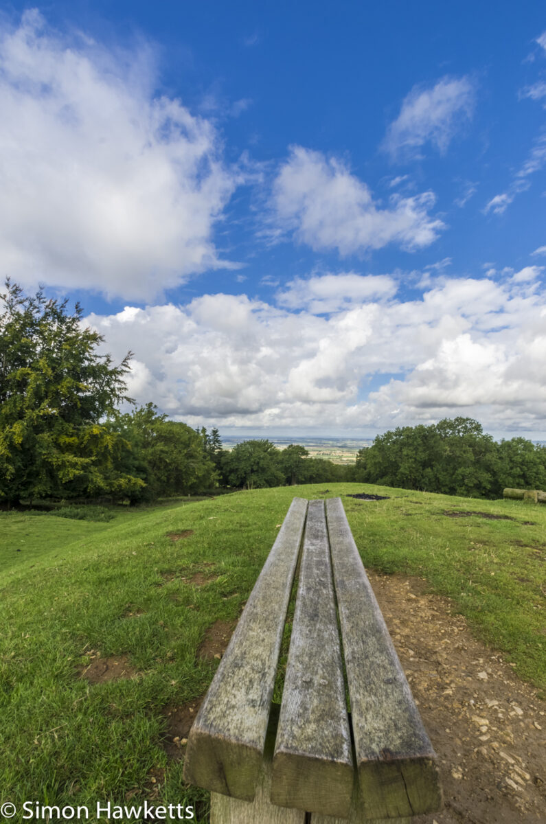 Looking down a bench over the gloucestershire countryside