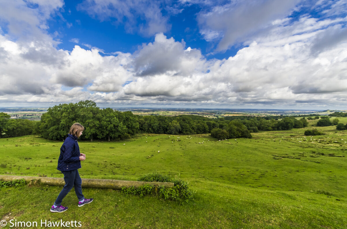A girl runs about the hillside at Dover's Hill